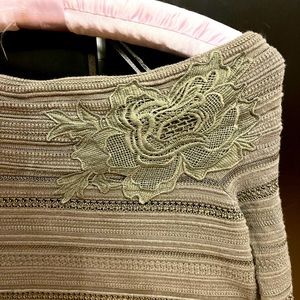 I-N-C off the shoulder top with exquisite detail.